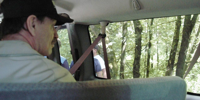 In this undated King County Prosecutor's Office handout photo, Green River killer Gary Leon Ridgway is seen as he takes investigators to one of the sights where he said he allegedly buried one of his victims. On November 5, 2003, in Seattle, Washington, Ridgway plead guilty to 48 murders dating back more than 20 years. In 2011, Ridgway pled guilty to the 1982 murder of his 49th victim, 20-year-old Rebecca Marrero.