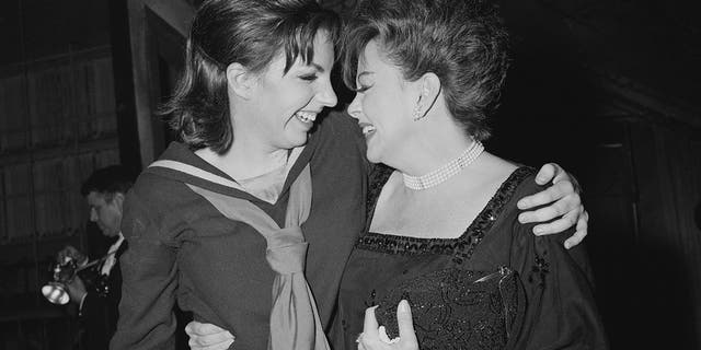 American actress and singer Liza Minnelli with her mother, American actress and singer Judy Garland (1922-1969), backstage after she opened in "Flora the Red Menace" at the Alvin Theatre, New York, circa 1965.