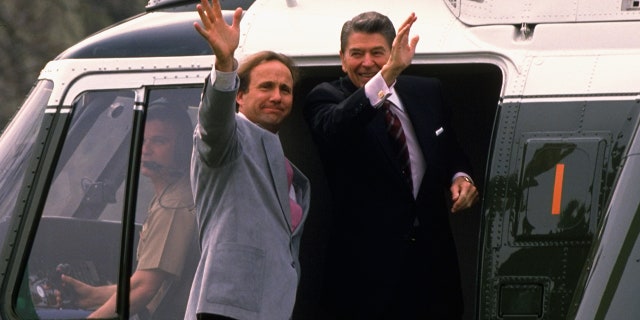 President Ronald Reagan with son Michael Reagan in the doorway of Marine One, departing for California, circa 1988.