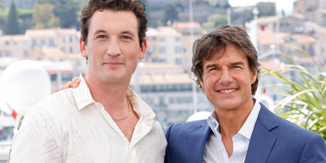 Miles Teller and Tom Cruise attend the photocall of "Top Gun: Maverick" during the 75th annual Cannes Film Festival at the Palais des Festivals on May 18, 2022 in Cannes, France.