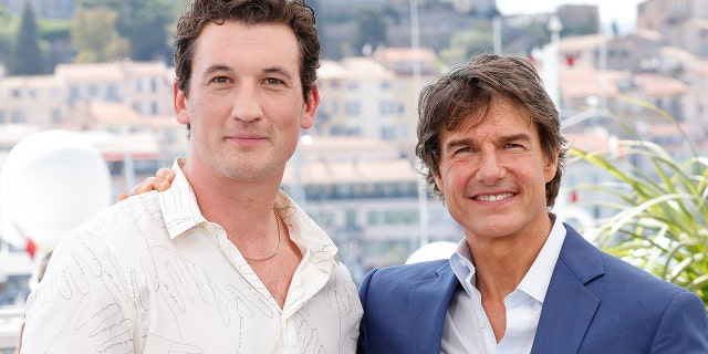 Miles Teller and Tom Cruise attend the photocall of "Top Gun: Maverick" during the 75th annual Cannes film festival at Palais des Festivals on May 18, 2022 in Cannes, France. 