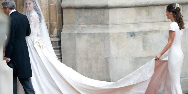 Catherine, Duchess of Cambridge and her father Michael Middleton arrive with Pippa Middleton for her wedding with Prince William at Westminster Abbey on April 29, 2011, in London.