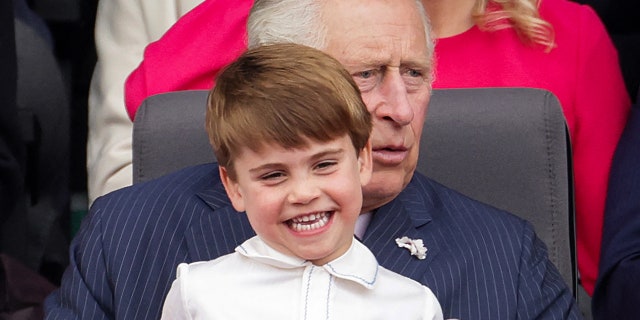 Prince Charles sits Prince Louis on his knee during the Platinum Pageant in London on June 5, 2022.