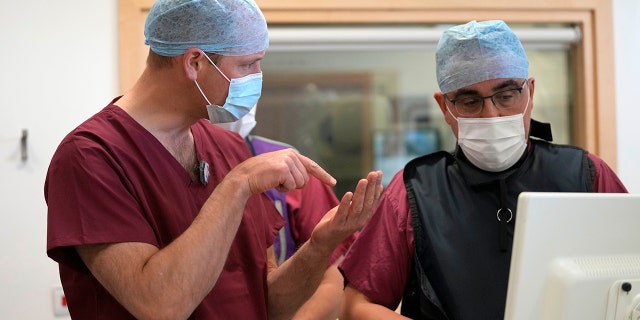 Prince William, Duke of Cambridge (L), President of The Royal Marsden NHS Foundation Trust, speaks to Dr. Nicos Fotiadis as he visits The Royal Marsden hospital to learn about some of the innovative work that is currently carrying out to improve cancer diagnosis and treatment on May 24, 2022, in London, England.