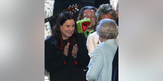 Queen Elizabeth is introduced to Ozzy Osbourne and Kermit the Frog on stage during "Party at the Palace" in 2002 as part of her Golden Jubilee celebrations.