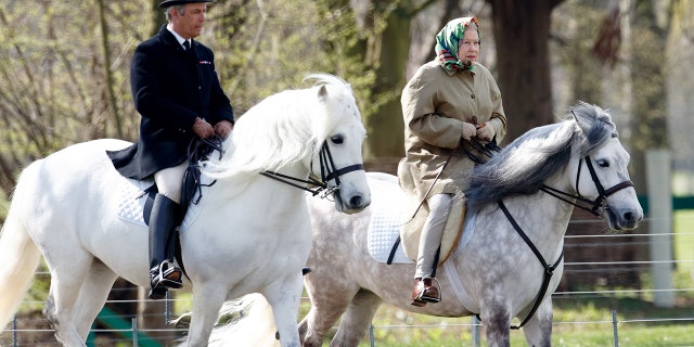 Queen Elizabeth II, accompanied by her Stud Groom Terry Pendry, is seen riding a horse on the grounds of Windsor Castle April 17, 2006, in Windsor, England. The reigning monarch has been suffering from mobility issues.