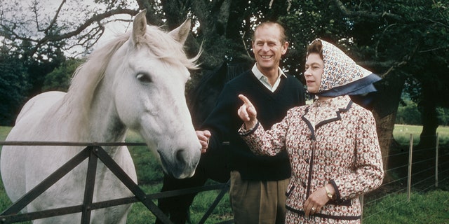 Queen Elizabeth II and Prince Philip visit a farm on the Balmoral estate in Scotland during their silver wedding anniversary year in September 1972. 
