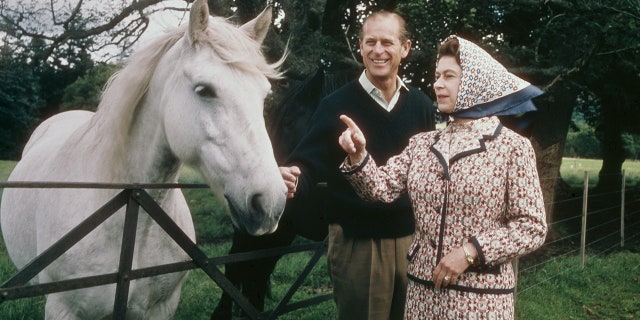 Queen Elizabeth II and Prince Philip visit a farm on the Balmoral estate in Scotland during their silver wedding anniversary year in September 1972.