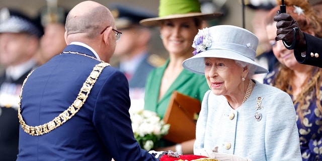 Lord Provost Robert Aldridge presents Queen Elizabeth II with the keys to the city of Edinburgh during The Ceremony of the Keys on the forecourt of the Palace of Holyroodhouse on June 27, 2022, in Edinburgh, Scotland. 