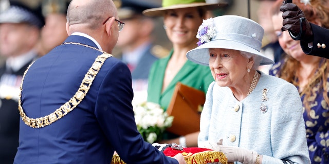 Lord Provost Robert Aldridge presents Queen Elizabeth II with the keys to the city of Edinburgh during The Ceremony of the Keys on the forecourt of the Palace of Holyroodhouse on June 27, 2022, in Edinburgh, Scotland.