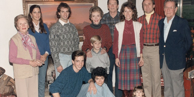 President Ronald Reagan and his family at Rancho del Cielo near Santa Barbara, California, Nov. 28, 1985. Standing from left, Bess Reagan, Patti Davis, Paul Grilley, Cameron Reagan, Nancy Reagan, the president, Colleen and Michael Reagan, and Neil Reagan. Foreground, from left, Ron, Doria and Ashley Marie Reagan.