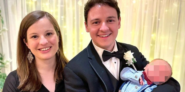 Gret Glyer and his wife, Heather Campbell Glyer, pose with their infant.