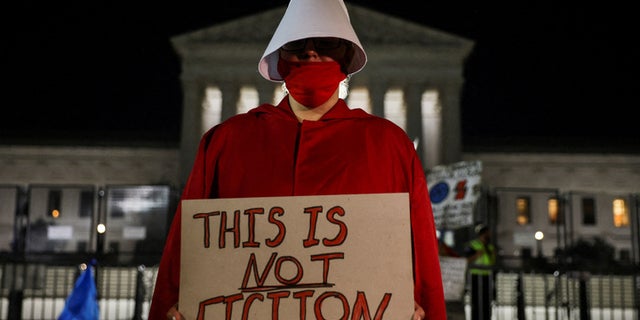 A pro-abortion protester stands out in front of the United States Supreme Court.