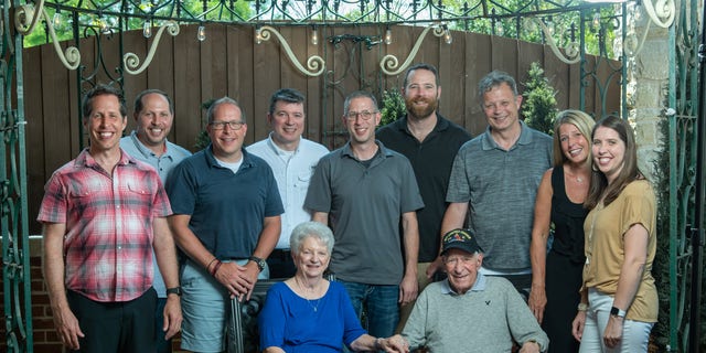 Whisler and wife Patricia with his nine grandchildren in 2021.