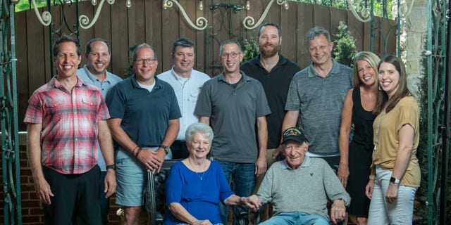 Whisler and wife Patricia with his nine grandchildren in 2021.