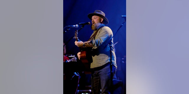 John Driskell Hopkins performs onstage for Georgia On My Mind at Ryman Auditorium on May 10, 2022 in Nashville, Tennessee. Hop formed his first band, Brighter Shade, with Andy Birdsall in 1996.