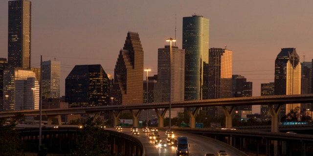 Traffic flows at dusk with the downtown Houston skyline in the background as night falls on America's fastest growing large city October 3, 2008. 