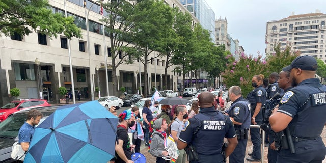Protesters blow whistles and bank on pots outside an "Our Bodies, Our Sports" rally in Washington, D.C. 