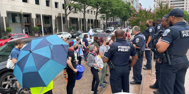 Protesters blow whistles and bank on pots outside an "Our Bodies, Our Sports" rally in Washington, D.C. 