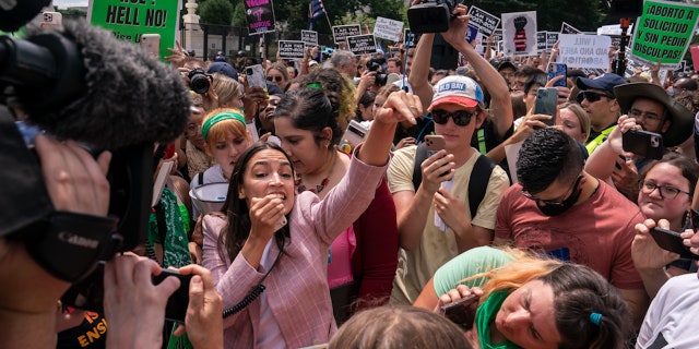 WASHINGTON, DC - JUNE 24: Rep. Alexandria Ocasio-Cortez (D-NY) speaks to abortion-rights activists in front of the U.S. Supreme Court after the Court announced a ruling in the Dobbs v Jackson Women's Health Organization case on June 24, 2022 in Washington, DC.  