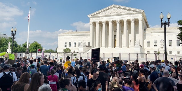 Demonstrators gather outside the Supreme Court in Washington, D.C., on June 24, 2022, the day the high court issued its monumental ruling on abortion.