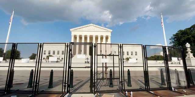 The United States Supreme Court remains surrounded by high metal fencing.