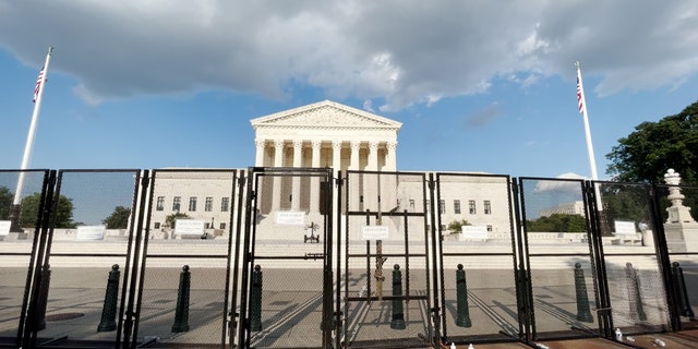 The U.S. Supreme Court remains surrounded by high metal fencing.