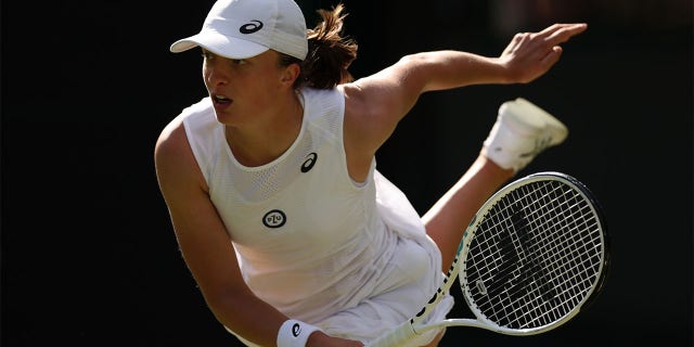 Iga Swiatek of Poland serves against Lesley Pattinama Kerkhove of the Netherlands during their second round match at Wimbledon 2022 at the All England Lawn Tennis and Croquet Club June 30, 2022, in London. 