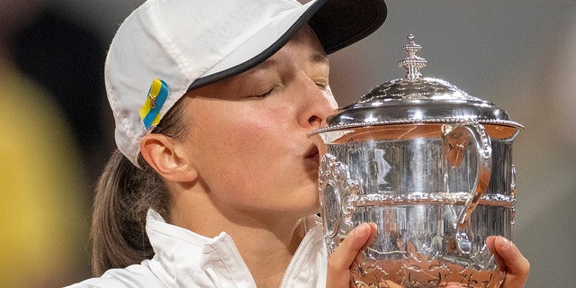 Iga Swiatek of Poland with the winner's trophy after her victory over Coco Gauff of the United States in the women's singles final on Court Philippe Chatrier at the 2022 French Open at Roland Garros June 4, 2022, in Paris.