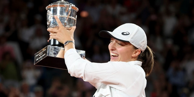 Iga Swiatek of Poland celebrates her victory during the trophy ceremony following the women's final against Coco Gauff at the French Open June 4, 2022, in Paris.