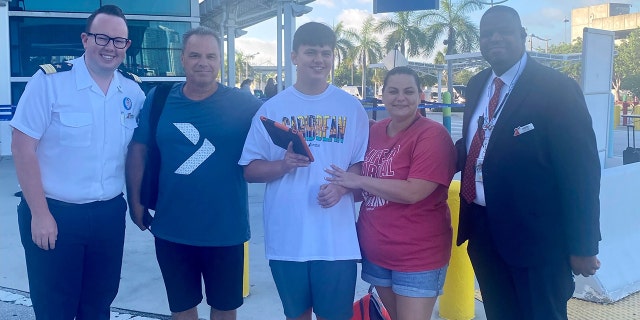 Three members of the Greene family of Toms River, N.J., are shown in the middle of this photo. In the center is son Elijah, 15.