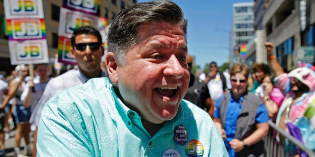 Illinois Gov.  JB Pritzker greets spectators during the Chicago Pride Parade in Chicago, Sunday, June 26, 2022.