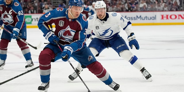 Colorado Avalanche defenseman Jack Johnson (3) controls the puck as Tampa Bay Lightning center Ross Colton (79) defends during the third period in Game 2 of the NHL hockey Stanley Cup Final, Saturday, June 18, 2022, in Denver.