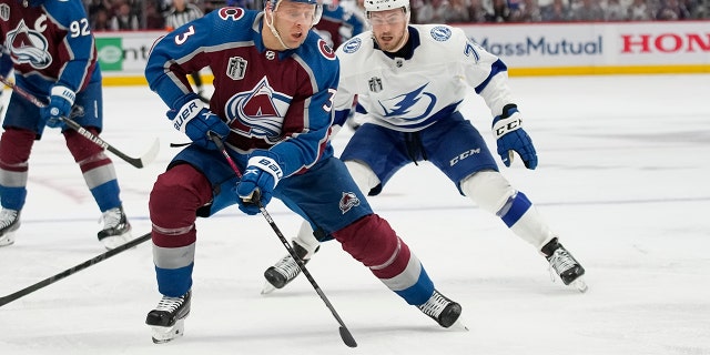 El sábado 18 de junio de 2022, en el Juego 2 de la final de la Copa Stanley de hockey de la NHL, el Tampa Bay Lightning Center Ross Colton (79) controla al defensor de Colorado Avalanche Jack Johnson (3) durante el tercer período.