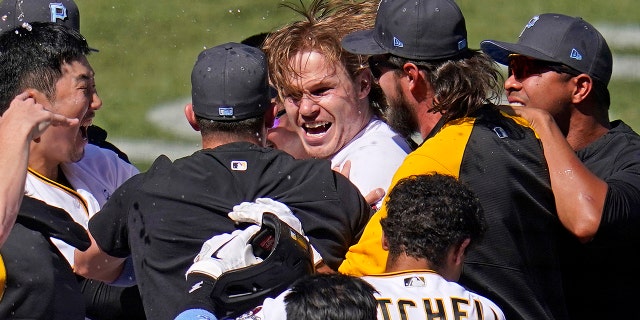 Pittsburgh Pirates' Jack Suwinski, center, is swarmed by teammates after hitting a walk-off solo home run off San Francisco Giants relief pitcher Tyler Rogers during the ninth inning of a baseball game in Pittsburgh, Sunday, June 19, 2022. It was Suwinski's third solo home run of the game.