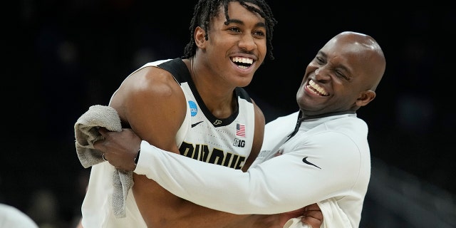 Jaden Ivey #23 of the Purdue Boilermakers celebrates with Assistant Coach Terry Johnson after defeating the Texas Longhorns 81-71 in the second round of the 2022 NCAA Men's Basketball Tournament at Fiserv Forum on March 20, 2022 in Milwaukee, Wisconsin.