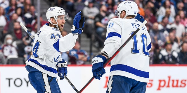 Tampa Bay Lightning defenseman Ian Rutta (44) and right winger Corey Perry (10) celebrate after scoring a goal in the first period of Game 5 of the Stanley Cup final between the Tampa Bay Lightning and the Colorado Avalanche at the Ball Arena in Denver, Colorado, June 24th.  , 2022.