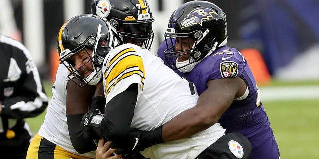 Linebacker Jaylon Ferguson, #45 of the Baltimore Ravens, tackles quarterback Ben Roethlisberger, #7 of the Pittsburgh Steelers, in the third quarter at M&amp;T Bank Stadium on November 01, 2020 in Baltimore, Maryland.