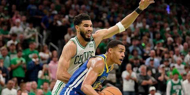 Golden State Warriors guard Jordan Poole looks to pass against Celtics forward Jayson Tatum during Game 6 of the NBA Finals, Thursday, June 16, 2022, in Boston.