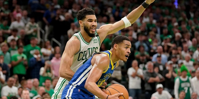 Golden State Warriors guard Jordan Poole looks to pass against Celtics forward Jayson Tatum during Game 6 of the NBA Finals, Thursday, June 16, 2022, in Boston.