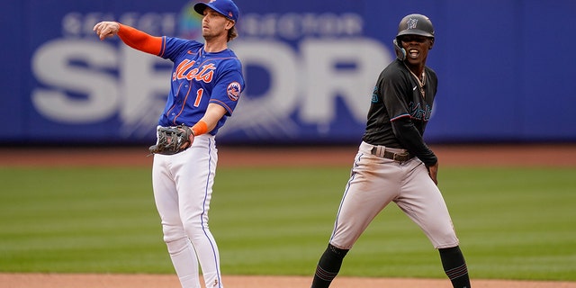 Miami Marlins' Jazz Chisholm Jr. reacts after stealing second base against New York Mets second baseman Jeff McNeil, left, in the seventh inning of a baseball game, Saturday, June 18, 2022, in New York.
