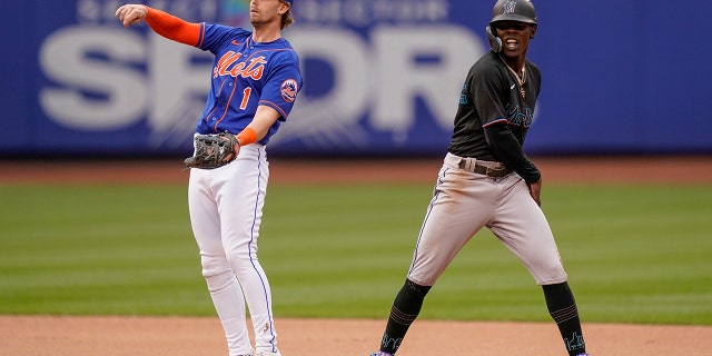 Miami Marlins' Jazz Chisholm Jr. reacts after stealing second base against New York Mets second baseman Jeff McNeil, left, in the seventh inning of a baseball game, Saturday, June 18, 2022, in New York.