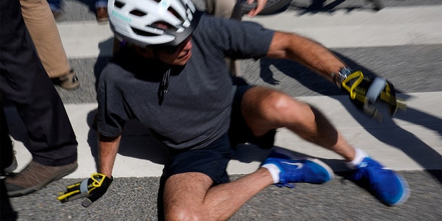 President Biden falls to the ground after running over a civilian while riding his bicycle in Rehoboth Beach, Delaware, June 18, 2022. REUTERS/Elizabeth Frantz