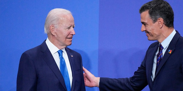 President Biden, links, talks to Spanish Prime Minister Pedro Sanchez at the official arrivals for the NATO summit in Madrid, Spanje, op Woensdag, Junie 29, 2022. (AP Photo/Bernat Armangue)