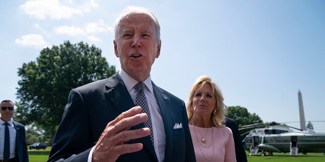 First Lady Jill Biden listens as President Biden talks to reporters about inflation before boarding Marine One on the South Lawn of the White House, Friday, June 17, 2022, in Washington. (AP Photo/Evan Vucci)