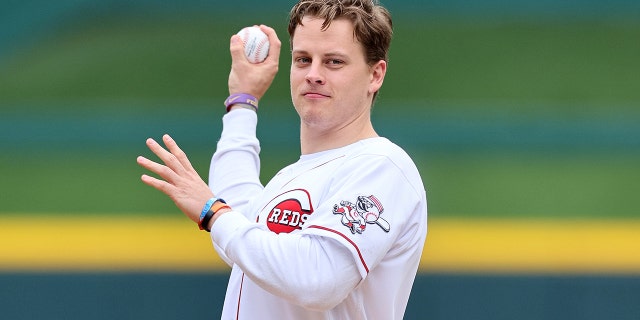 Joe Burrow of the Cincinnati Bengals throws out the ceremonial first pitch before the Cincinnati Reds game against the Cleveland Guardians at Great American Ball Park on April 12, 2022 in Cincinnati, Ohio.