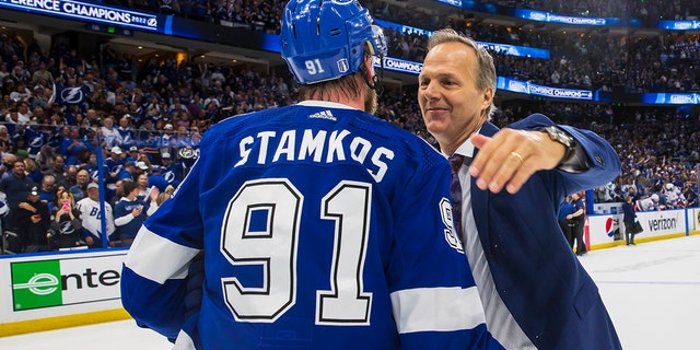Steven Stamkos #91 and Tampa Bay Lightning head coach John Cooper celebrate their series win against the New York Rangers following game six of the Eastern Conference Finals of the 2022 Stanley Cup Playoffs at Amalie Arena on June 11, 2022 in Tampa, Florida.