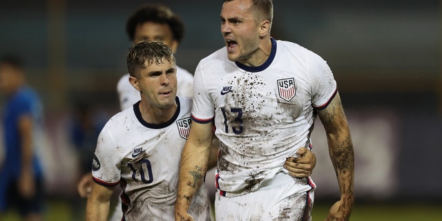 Jordan Morris #13 of the United States celebrates scoring a goal with teammate Christian Pulisic #10 during a Concacaf Nations League game between El Salvador and the United States at Estadio Cuscatlan on June 14, 2022 in San Salvador, El Salvador.