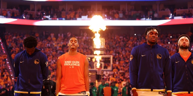 Andrew Wiggins #22, Jordan Poole #3, Kevon Looney #5, and Klay Thompson #11 of the Golden State Warriors stand for the National Anthem prior to playing the Boston Celtics in Game Two of the 2022 NBA Finals at Chase Center on June 05, 2022 in San Francisco, California.