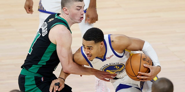 Golden State Warriors guard Jordan Poole, right, is defended by Boston Celtics guard Payton Pritchard during the first half of Game 5 of basketball's NBA Finals in San Francisco, Monday, June 13, 2022.